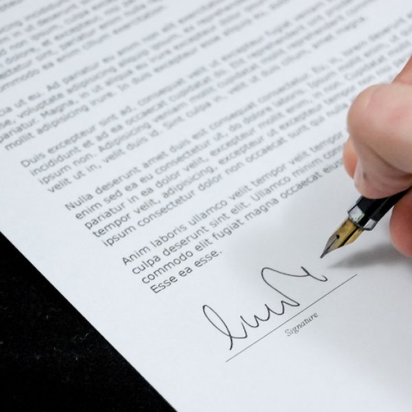 person giving signature on a document